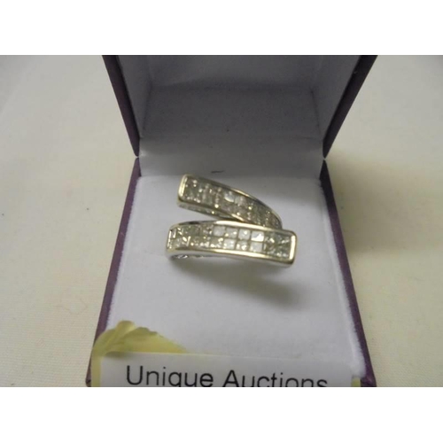 10 - An 18ct gold two bar diamond designer ring, size K, 6.8 grams.