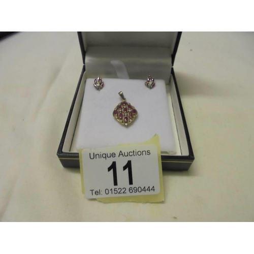 11 - A yellow gold diamond and ruby pendant and earring set, 3.6 grams.