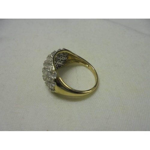 13 - An 18ct white gold diamond swirl ring, size P, 5.7 grams.