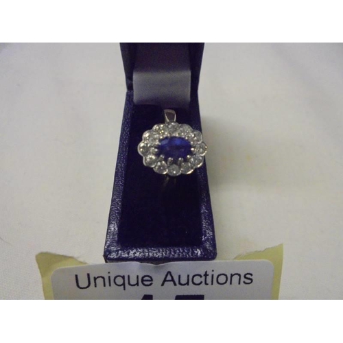 15 - An 18ct gold oval sapphire and diamond ring, size M half, 3.6 grams.