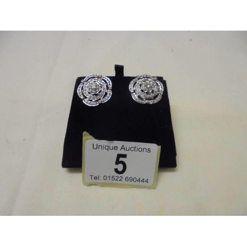 5 - A large pair of platinum and diamond earrings (centre stones 25pt), 9 grams.