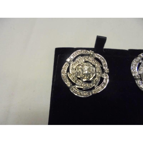 5 - A large pair of platinum and diamond earrings (centre stones 25pt), 9 grams.