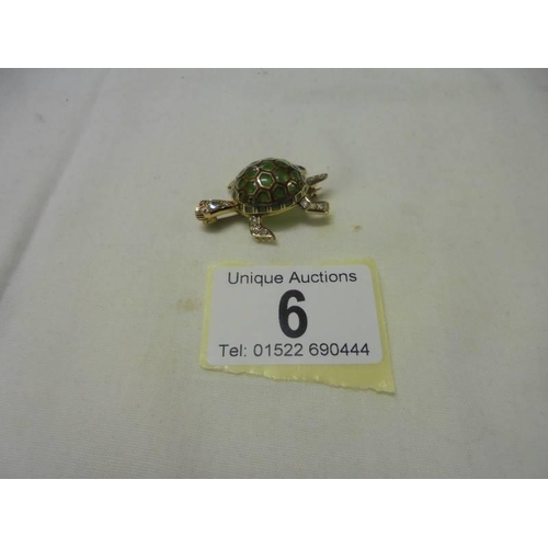 6 - An 18ct yellow gold diamond and emerald tortoise brooch, 10.8 grams.