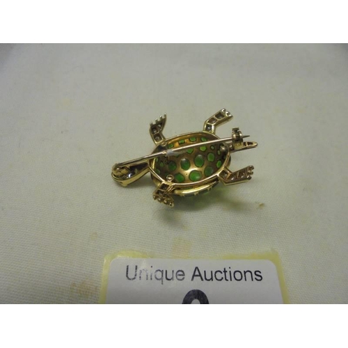 6 - An 18ct yellow gold diamond and emerald tortoise brooch, 10.8 grams.
