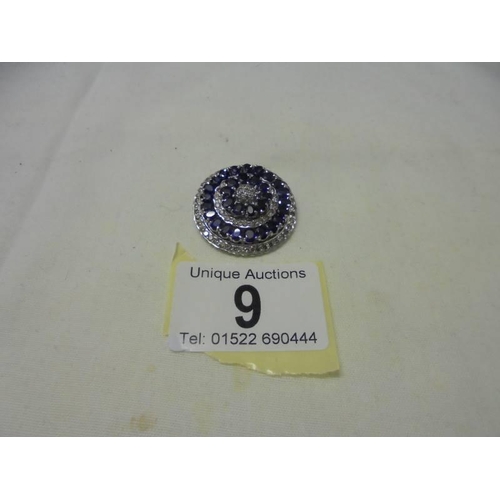9 - An 18ct white gold diamond and sapphire pendant, 14.5 grams.