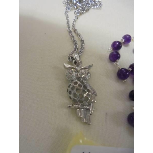 1021 - A silver and bead necklace, a pair of silver and purple stone earrings and a white metal owl pendant... 