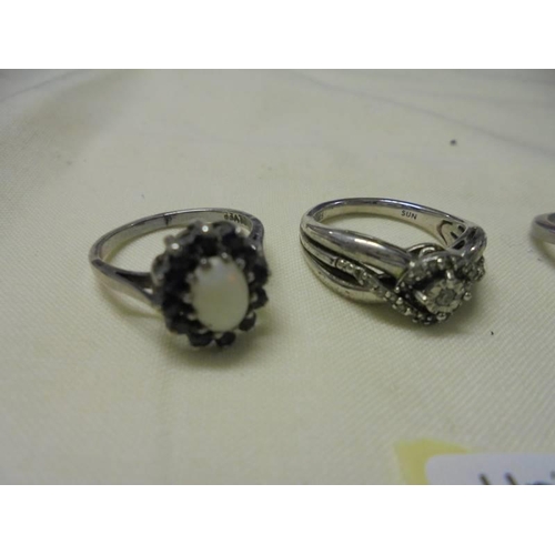 1023 - Four assorted silver rings.