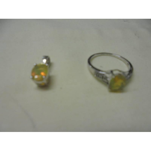 1024 - Two silver rings with matching pendants.