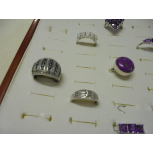 1032 - A good quality ring case with eight assorted silver rings.