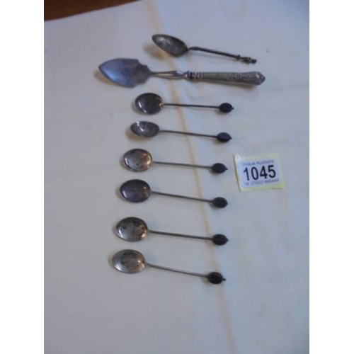 1045 - Six silver coffee bean spoons, a silver handled sugar spoon and an unmarked spoon.