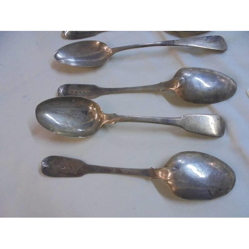 1046 - Seven silver dessert spoons.