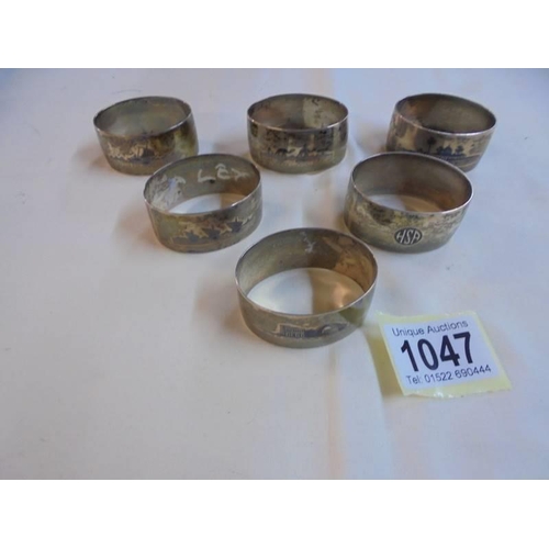 1047 - A set of six napkin rings monogrammed H S P and with middle eastern scenes on reverse (possibly silv... 