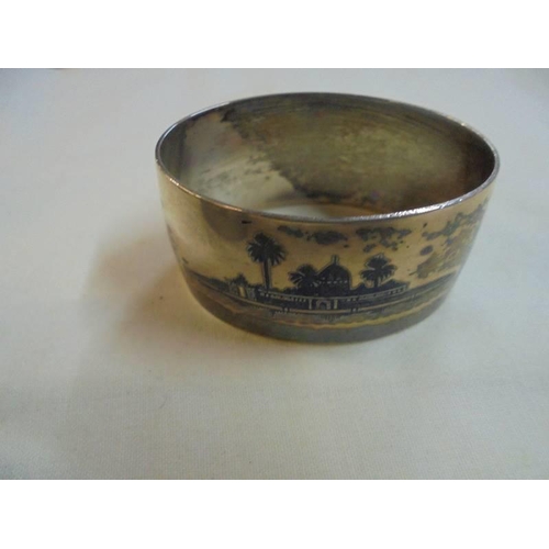 1047 - A set of six napkin rings monogrammed H S P and with middle eastern scenes on reverse (possibly silv... 