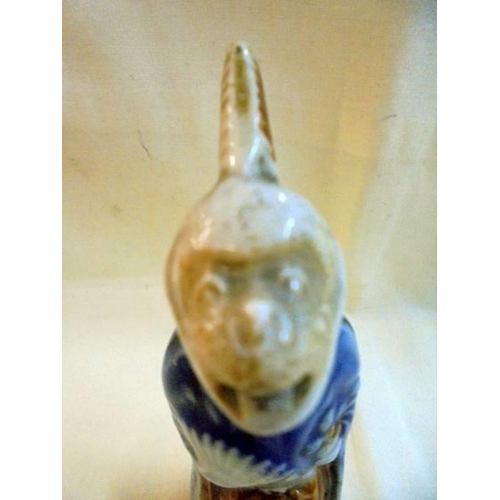 1050 - A Japanese ceramic monkey with pulling tongue (late 19/early 19C) a/f (crack down side of back)