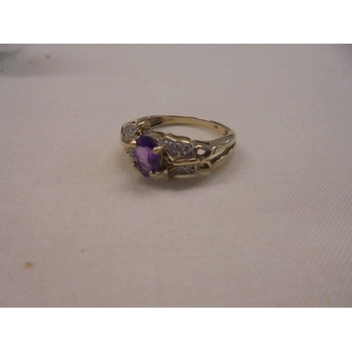 1055 - An amethyst/diamond set ring in 9ct gold , size N, 2.9 grams.