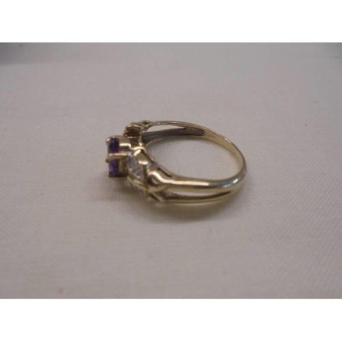 1055 - An amethyst/diamond set ring in 9ct gold , size N, 2.9 grams.