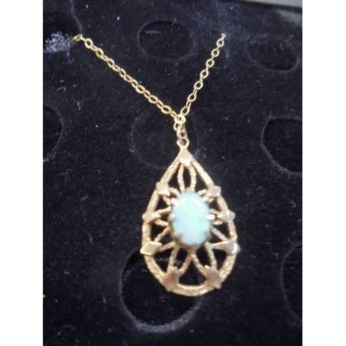 1060 - A 9ct gold opal set pendant in an openwork mount.