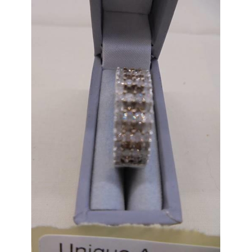 1061 - A champagne and white diamond band ring set with round and baguette diamonds in white metal stamped ... 