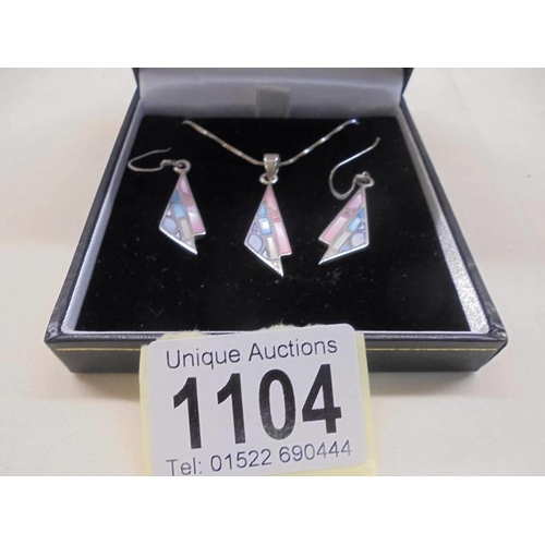 1104 - A silver pendant with matching earrings by Anne McFarlane.