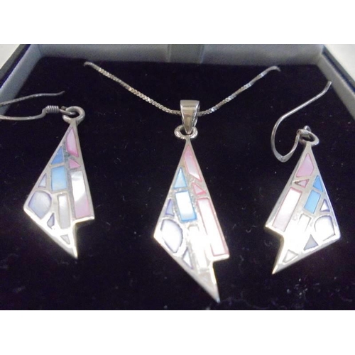 1104 - A silver pendant with matching earrings by Anne McFarlane.