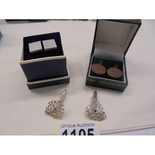 1105 - Two pairs of silver cuff links and a pair of rollled gold cuff links.