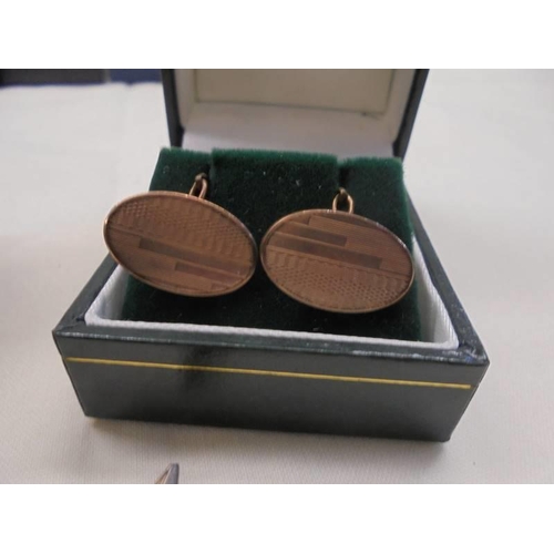 1105 - Two pairs of silver cuff links and a pair of rollled gold cuff links.