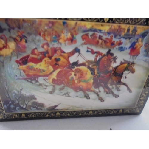 1127 - A Russian lacquered box featuring a winter scene and a lacquered brooch.