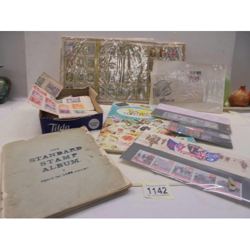 1142 - An album of stamps, loose stamps and an empty stamp album.