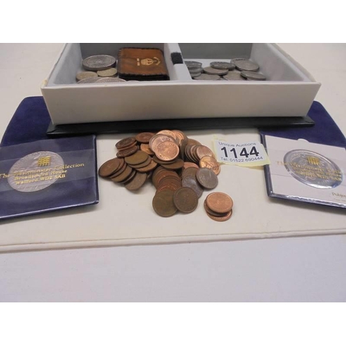 1144 - A box of assorted coins including Churchill crowns.