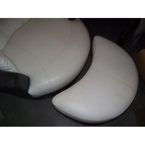 211 - A large black and white leather rotating armchair and footstool  COLLECT ONLY