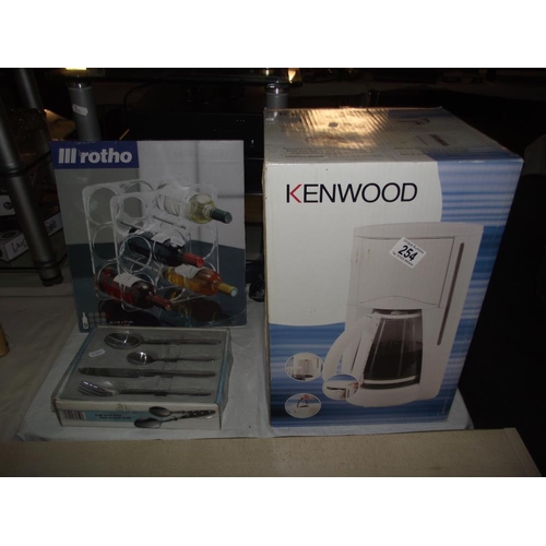 254 - A new boxed Kenwood coffee maker, wine rack and box of cutlery