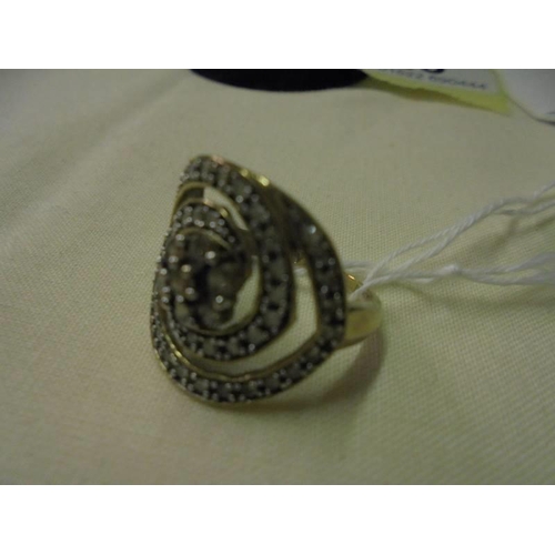 23 - A 9ct yellow gold large swirl diamond set ring, size N, 3.1 grams.