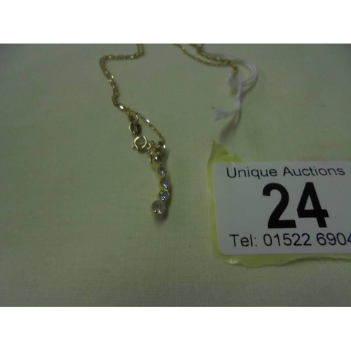 24 - A diamond pendant set brilliants and two yellow diamonds on a 9ct gold chain, 1.6 grams.
