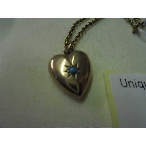 26 - A 9ct gold heart pendant set turquoise on a yellow metal chain.