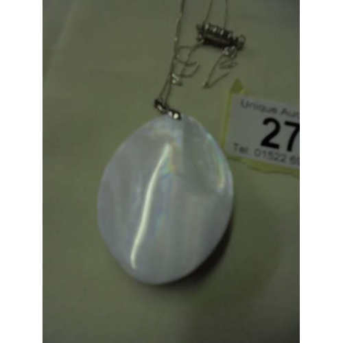 27 - A Paua shell pendant on a silver chain.