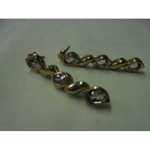 30 - A pair of 9ct gold drop earrings set lilac coloured stones, 5.5 grams.