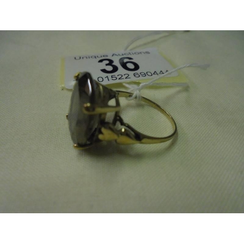 36 - A 9ct gold ring set smoky stone, size L, 3.3 grams.