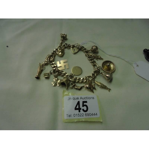 45 - A 9ct gold charm bracelet with sixteen charms, 47.2 grams.