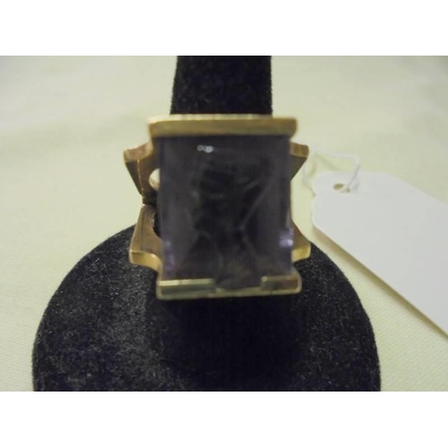 50 - A 9ct gold ring set blue stone with carved Egyptian head, size L, 10.7 grams/