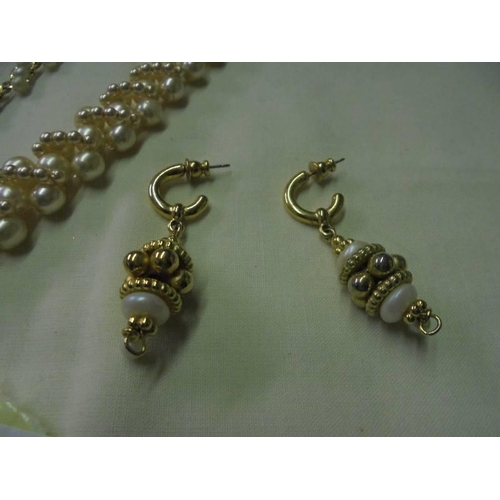 62 - A pearl necklace, bracelet and earrings.