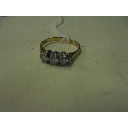 74 - An 18ct gold ring set with triple diamonds (approximately 0.33 ct), Size L, 2.2 grams.