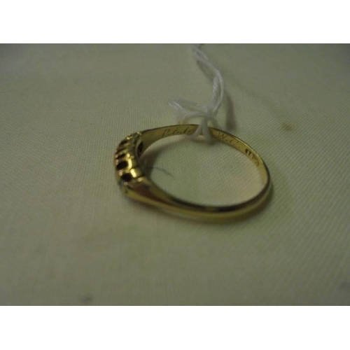 75 - An 18ct gold ring set with five diamonds (approximately 0.15 ct), size O, 2.2 grams.