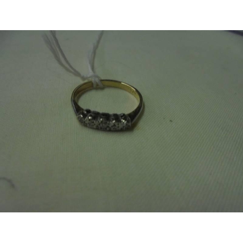 76 - An 18ct gold ring set with five diamonds, size M, 2.3 grams.