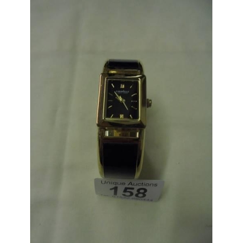 158 - A Caravelle New York black enamel bangle watch.
