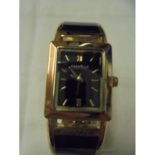 158 - A Caravelle New York black enamel bangle watch.