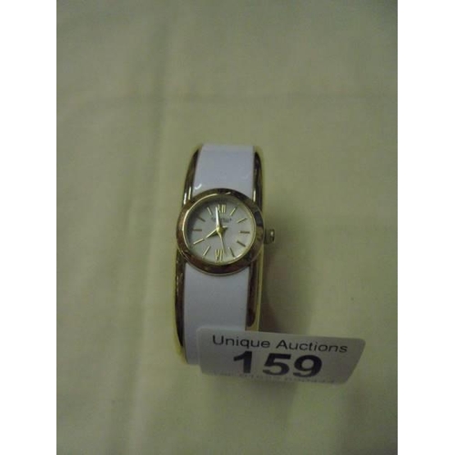 159 - A Caravelle New York white enamel bangle watch.