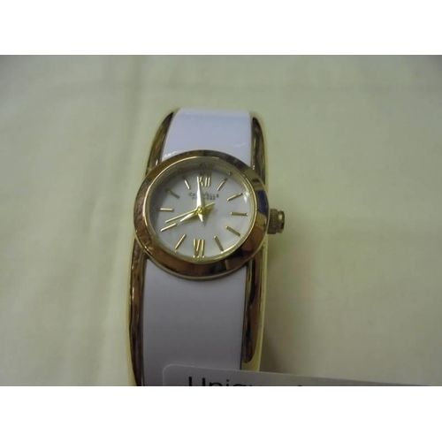 159 - A Caravelle New York white enamel bangle watch.