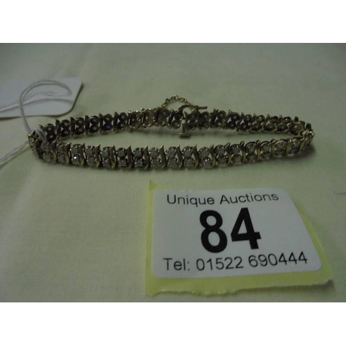 84 - A 9ct gold bracelet set diamonds stones, total weight 11.9 grams. (19cm in length)