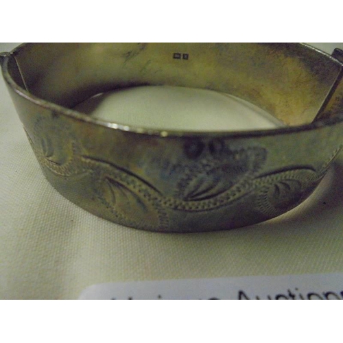 90 - An engraved silver bangle.