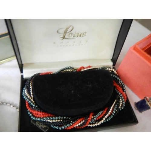 603 - A jewellery box with costume jewellery including cased Lotus multi-coloured necklace.